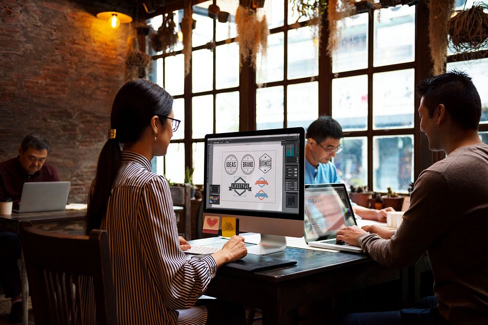 Group of designers working together in a cafe