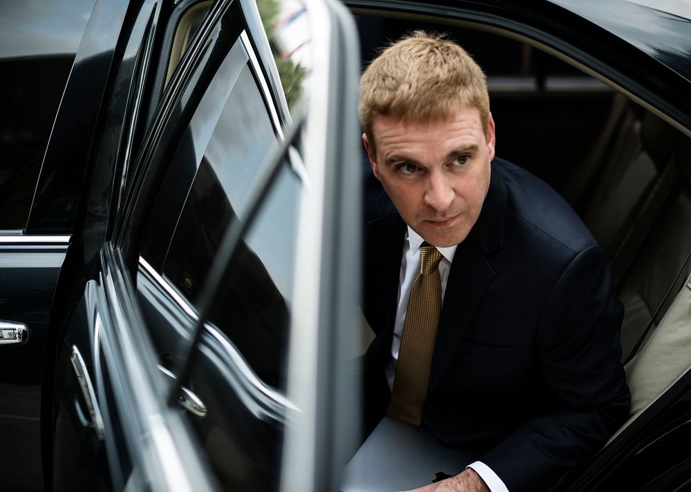 Businessman going out of his car