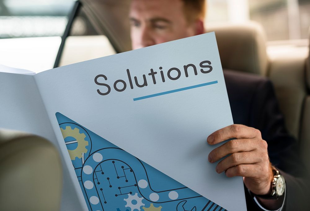 Entrepreneur reading neswpaper in the car solutions word