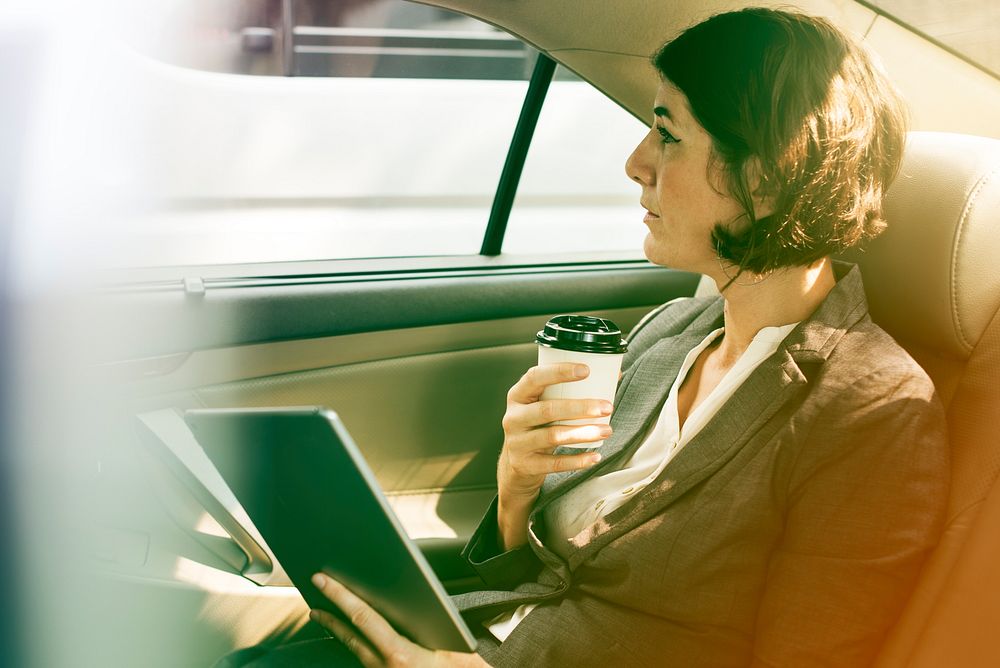 Businesswoman Using Tablet Car Inside