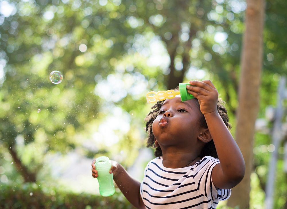 African kid playing with bubbles