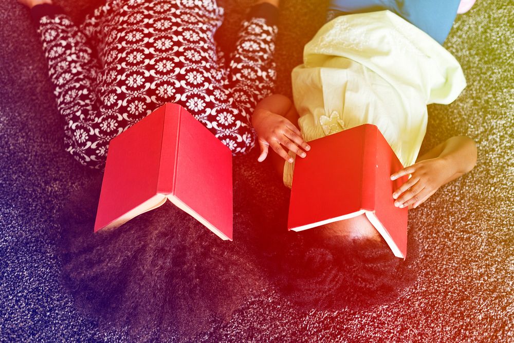 African sisters take a rest from reading books