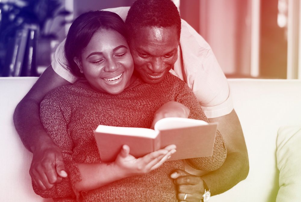 African American Couple Read Book Together