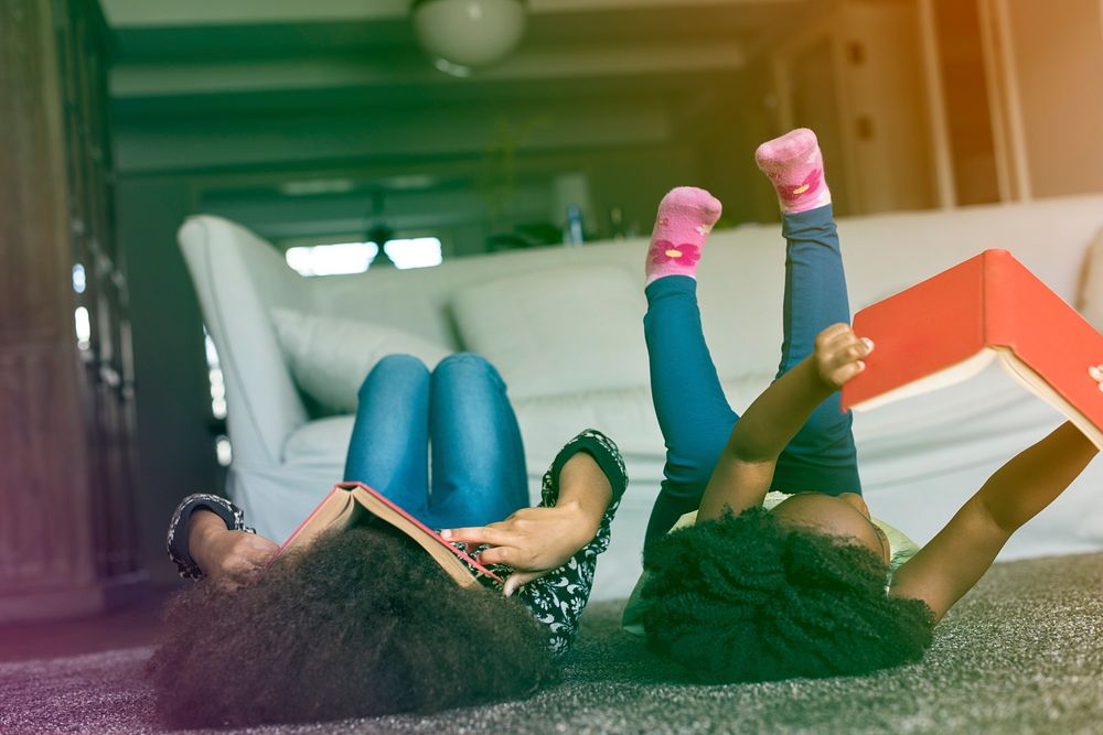 Little Girls Lay On The Floor Reading Book Sisterhood