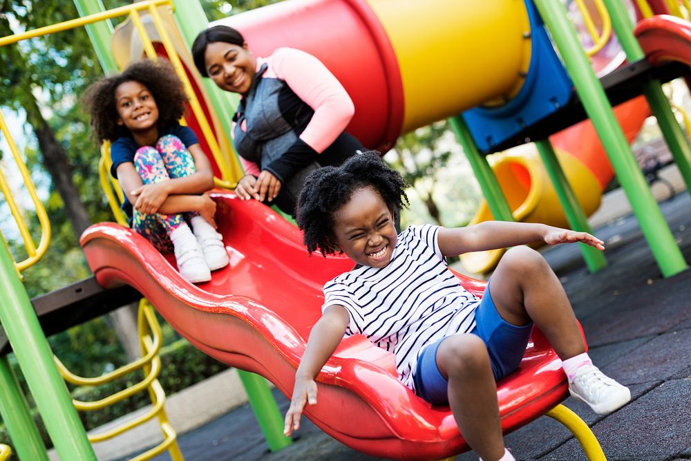 African mother with her two children having fun on a park