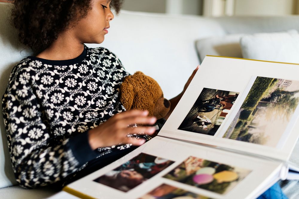 African child looking through a photobook