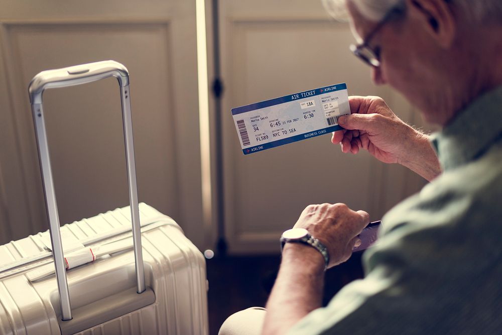 Senior Man Hands Hold Plan Ticket Luggage