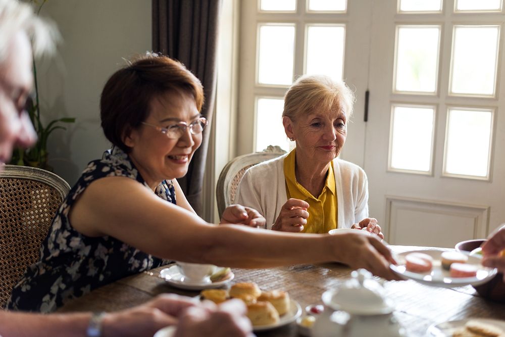 Elderly people having tea party together