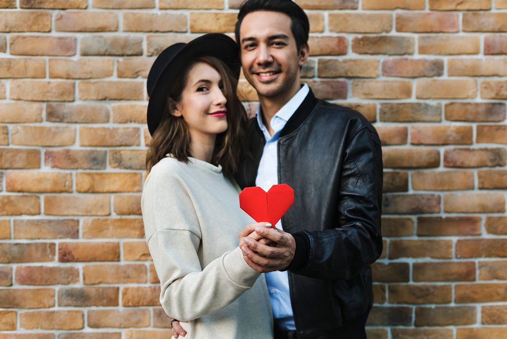 Romantic couple holding a heart