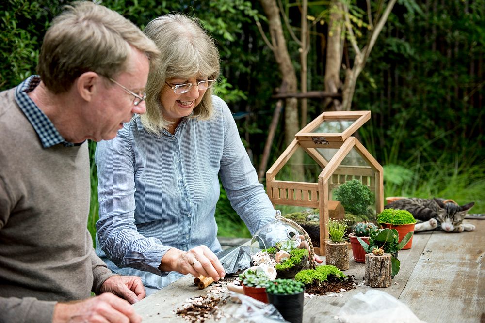 Elderly senior couple gardening together 