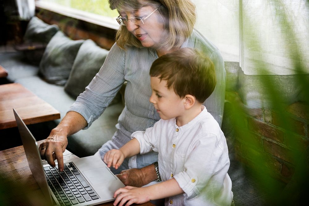 Grandmother and grandson using the laptop together