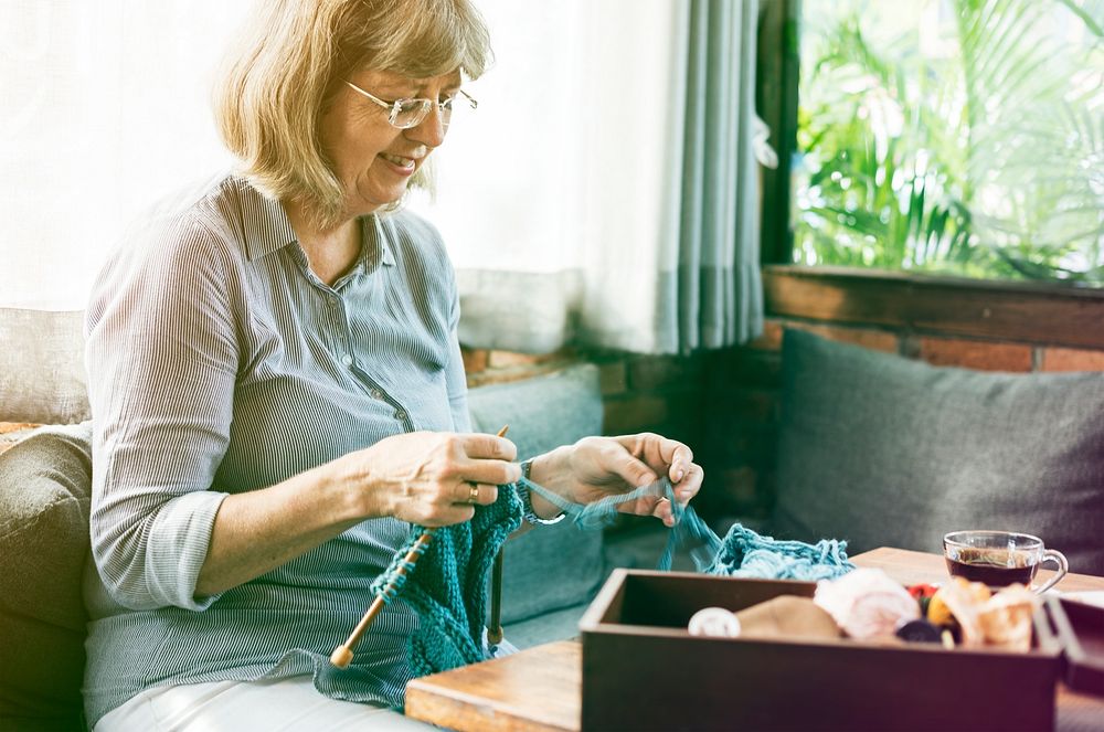 Senior adult woman has knitting activity