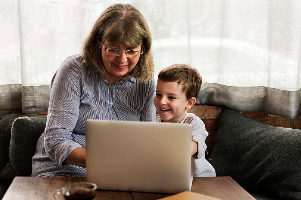 Grandmother and grandson using the laptop together