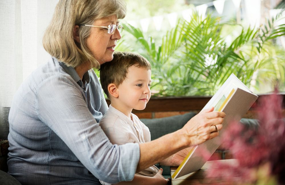 Grandmother and grandson reading a book together