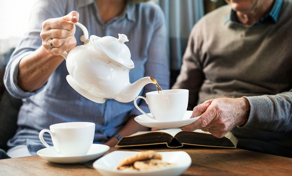Elderly couple enjoying tea togetheraving 