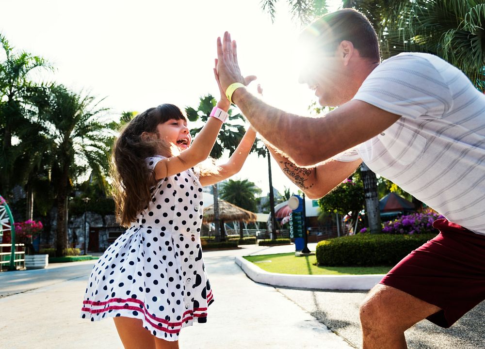 Daughter and dad doing a high five