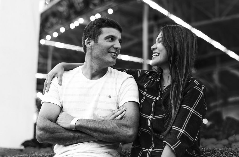 Grayscale couple cheerful staring at each other