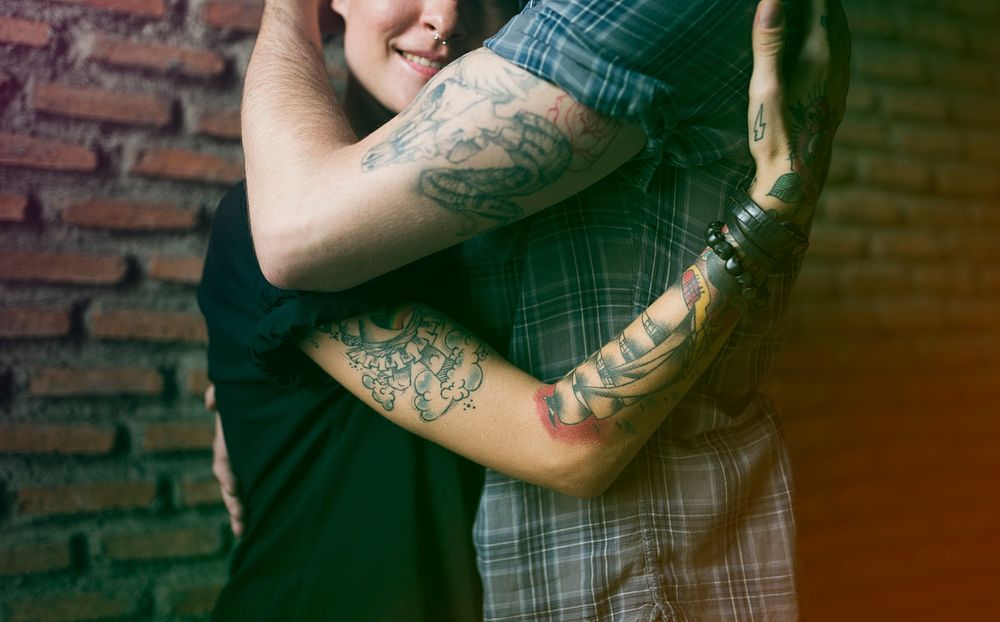 Hipster couple hugging together with love