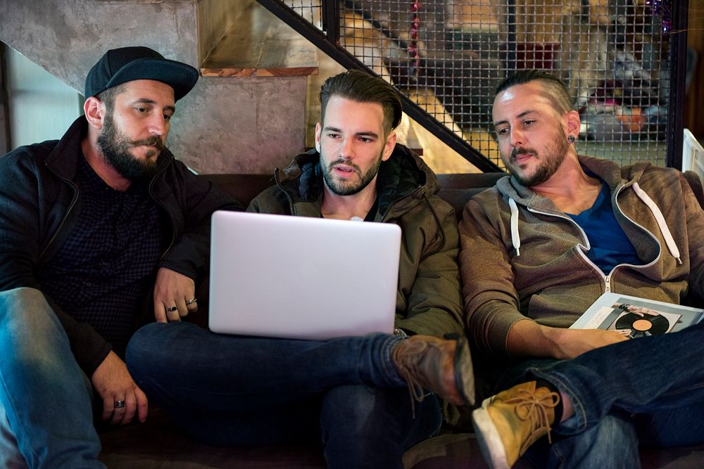 Group of men looking on the laptop