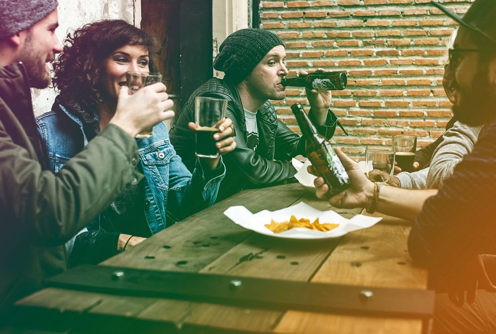 Group of people having beer at night club