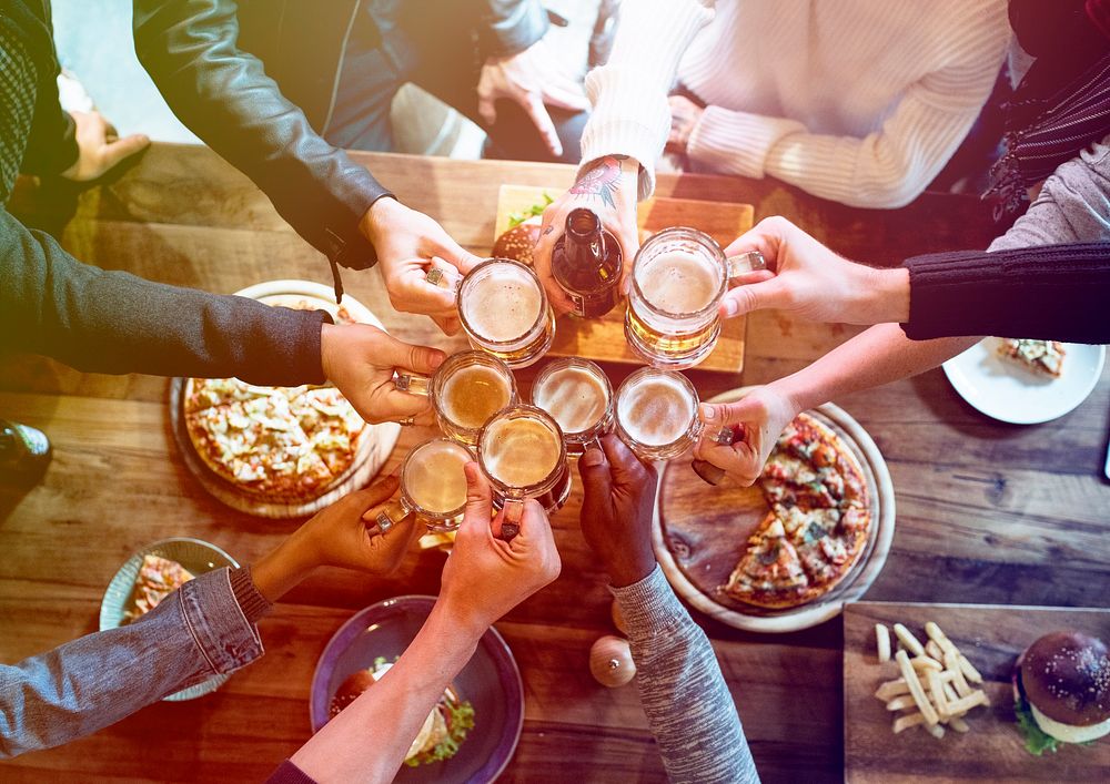 Group of people celebrate party with food and beer