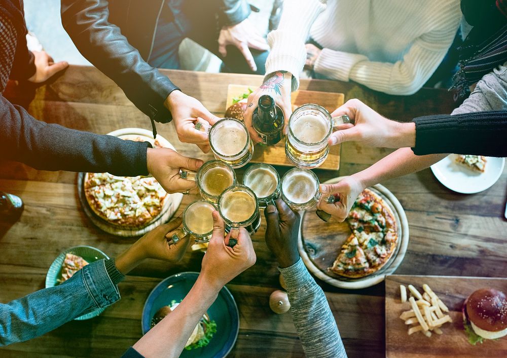 Group of people celebrate party with food and beer