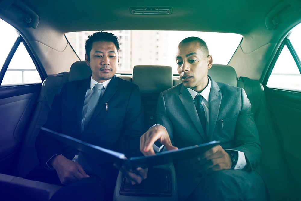 Businessmen explaining about report in the car