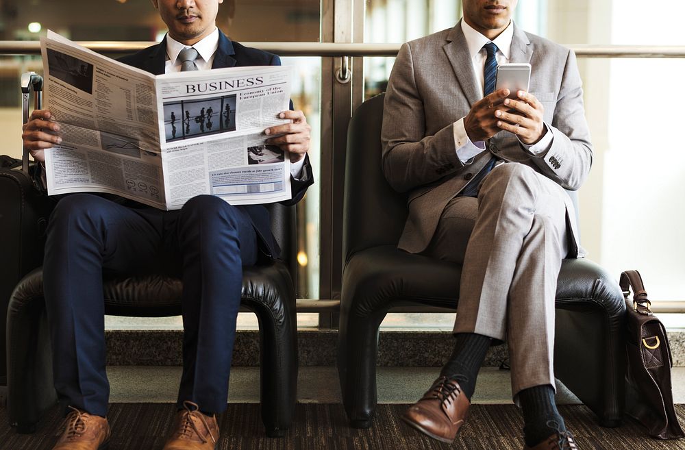 Businessmen reading the news