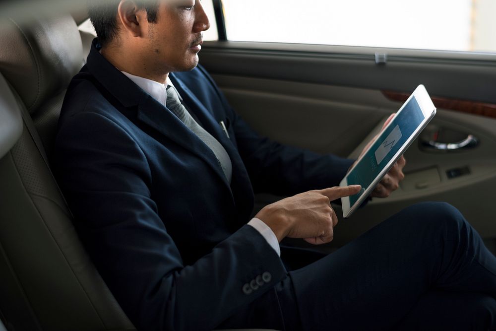 Businessman Use Tablet Inside Car