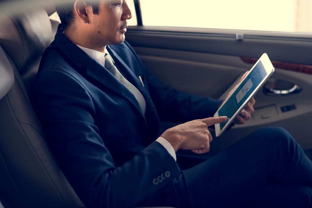 Businessman Use Tablet Inside Car