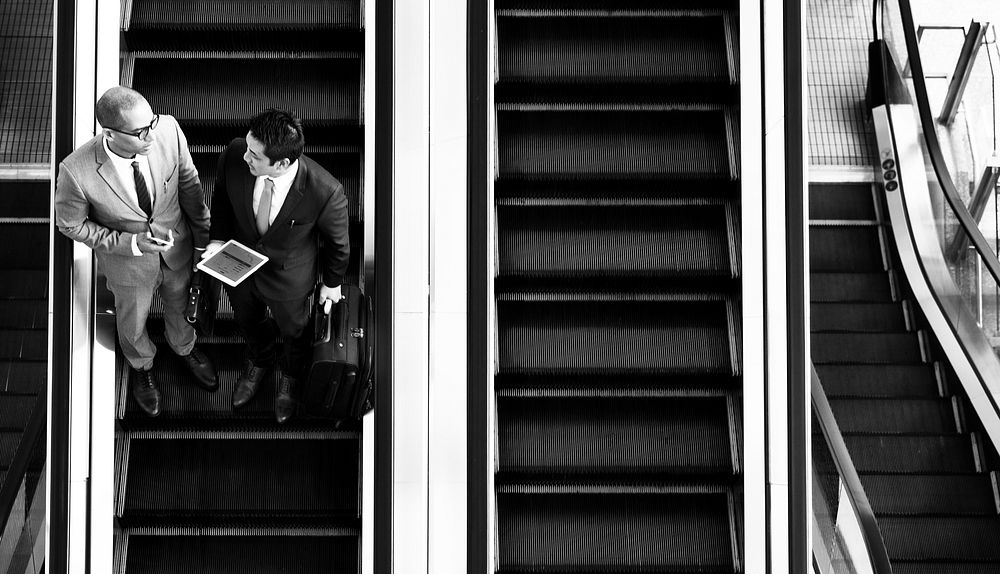 Businessmen on the escalator
