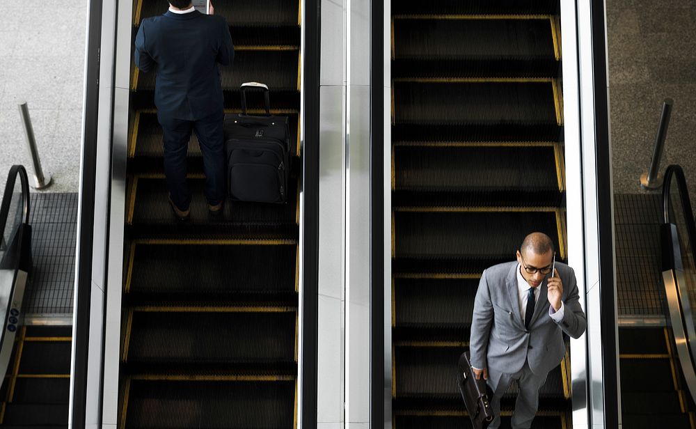 Business Men Escalator Talk Mobile