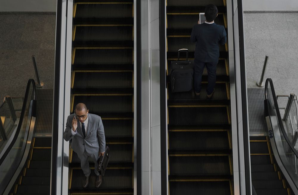 Business Men Escalator Talk Mobile