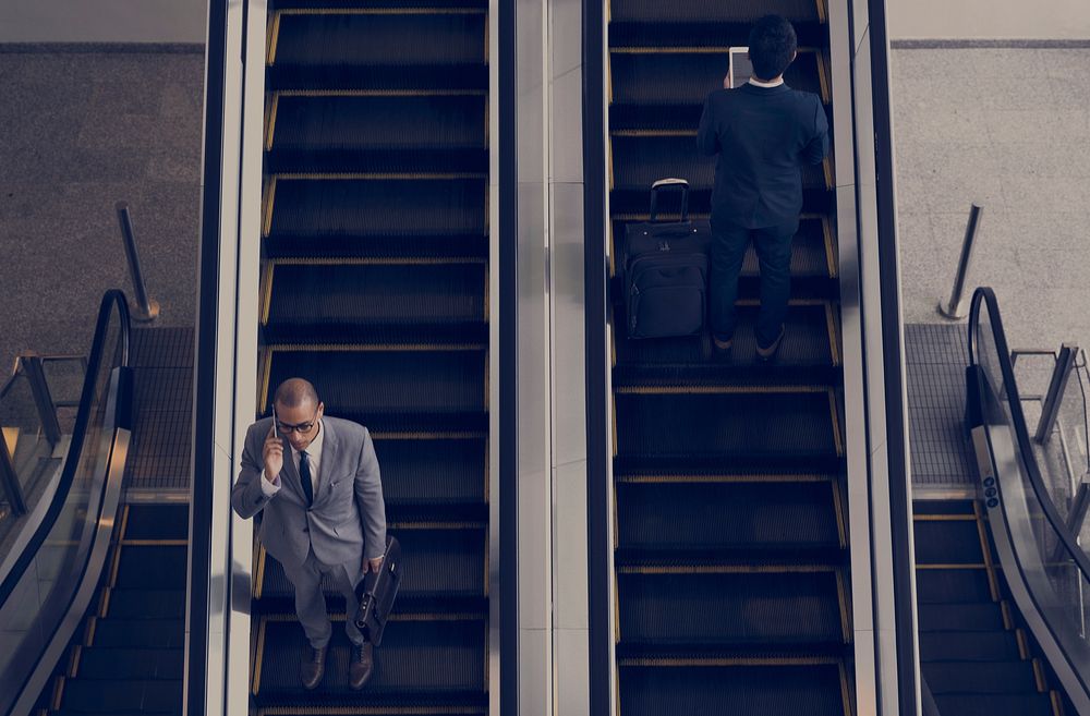 Business Men Escalator Talk Mobile
