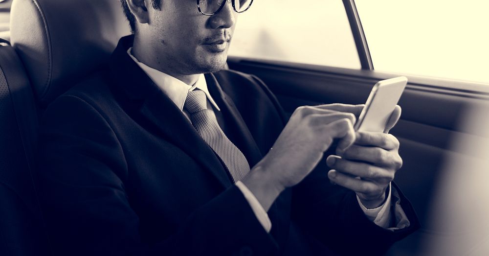 Businessman Use Mobile Inside Car