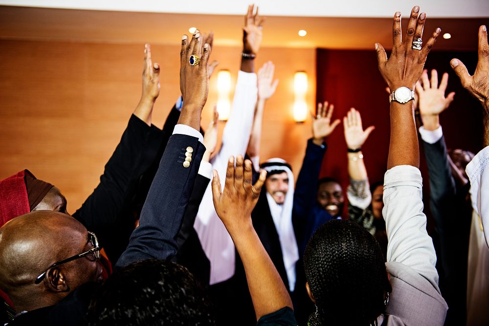 A Group of International Business People Raising Hands 