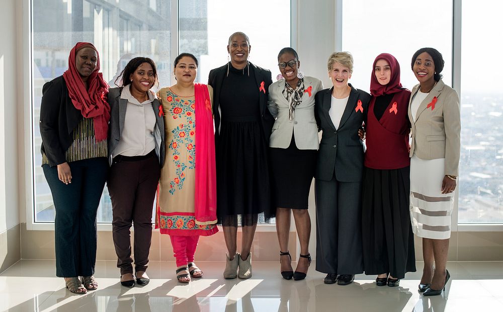 A Group of Business Women Are HOlding One Anotehldine o