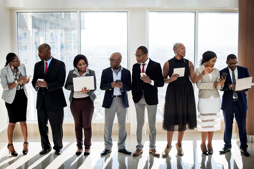 A Group of International Business People Are Standing and Using Wireless Devices 