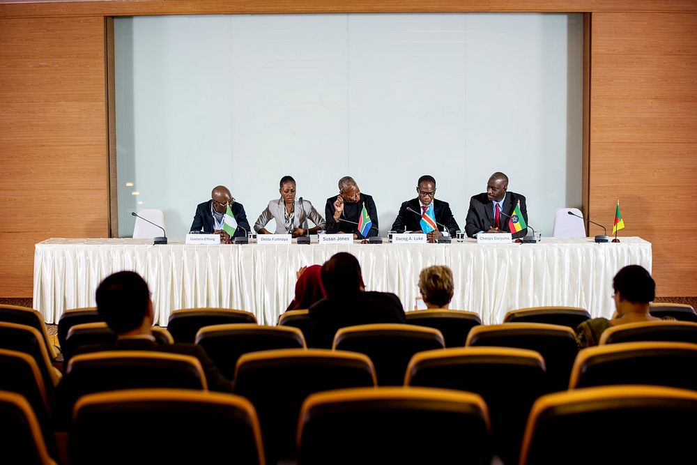 A Group of Business People Participating in a Panel Discussion with Audiences