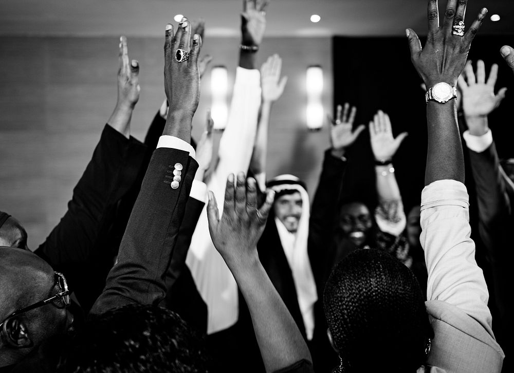 A Group of International Business People Are Raising Their Hands