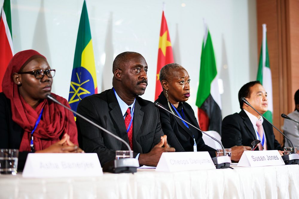 A Group of International Business Delegates in a Forum Discussion