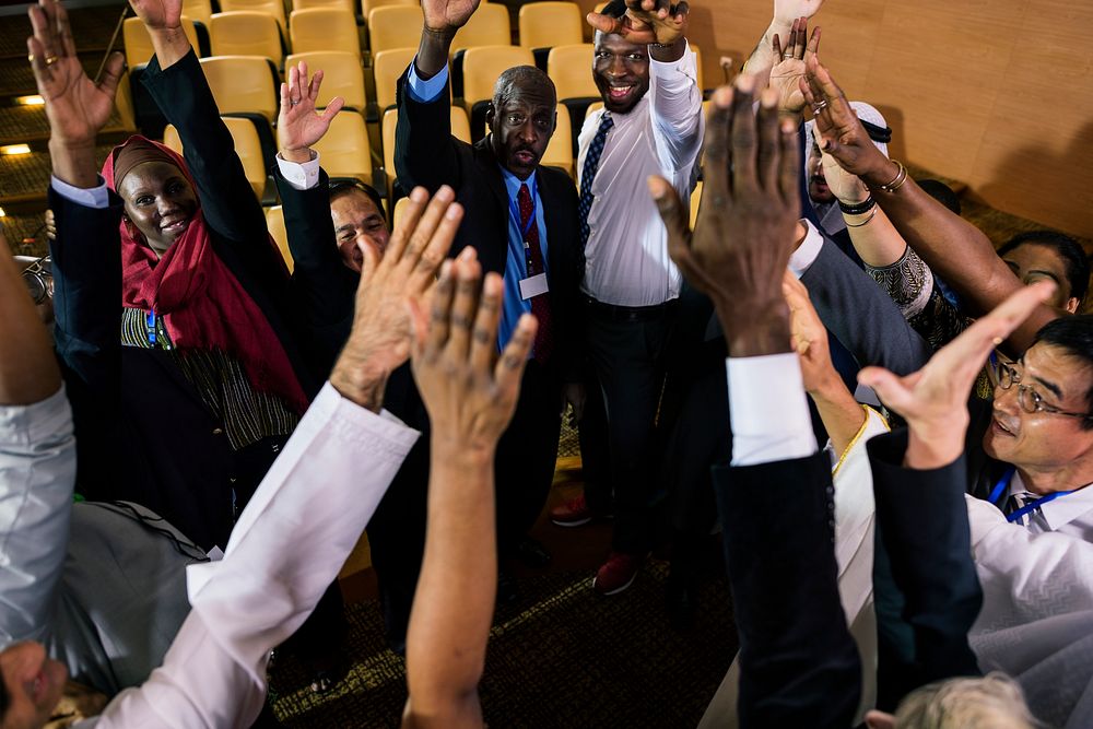 A Group of International Business People Are Raising Their Hands