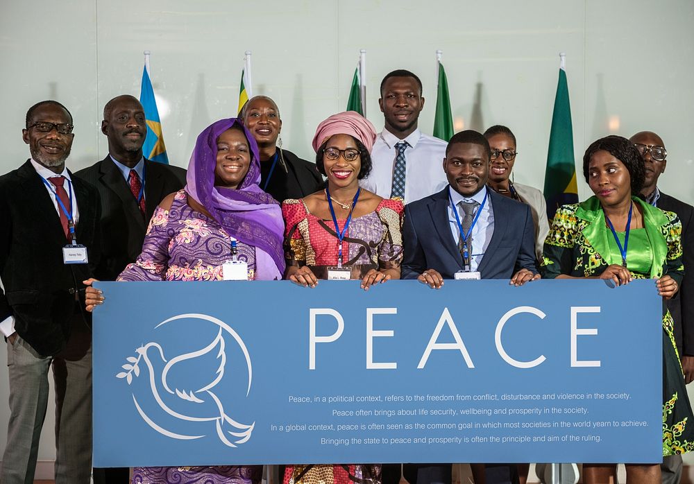 A Group of International Business People Showing a Peace Sign and Smiling 