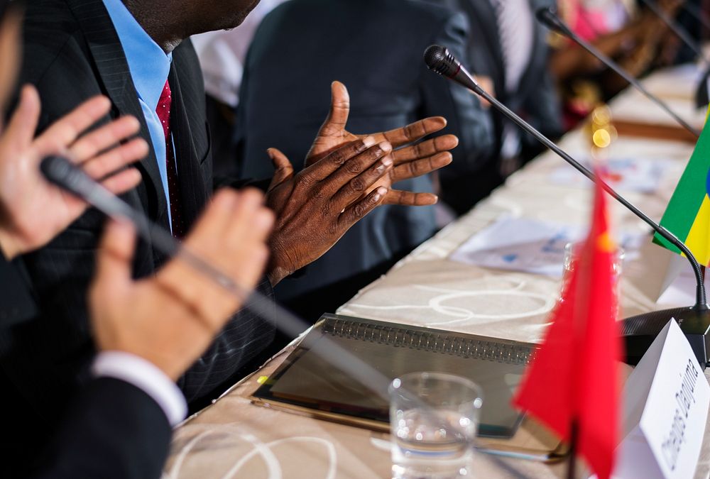 A Group of International Business People in a Meeting Clapping Their Hands