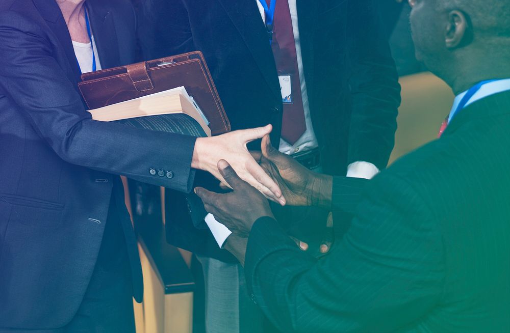 Business people handshaking deal together