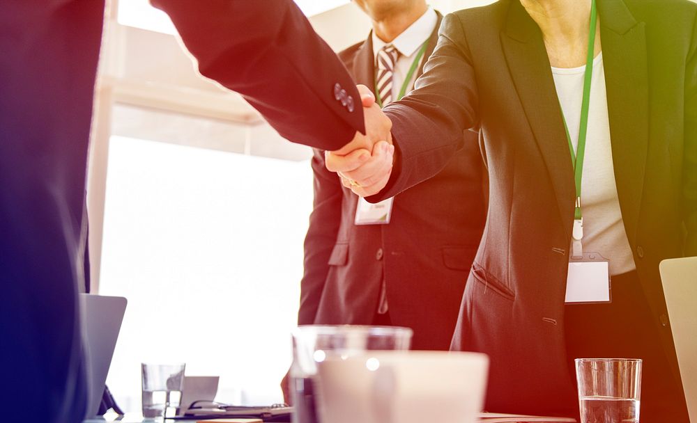 Business people greeting handshaking deal together