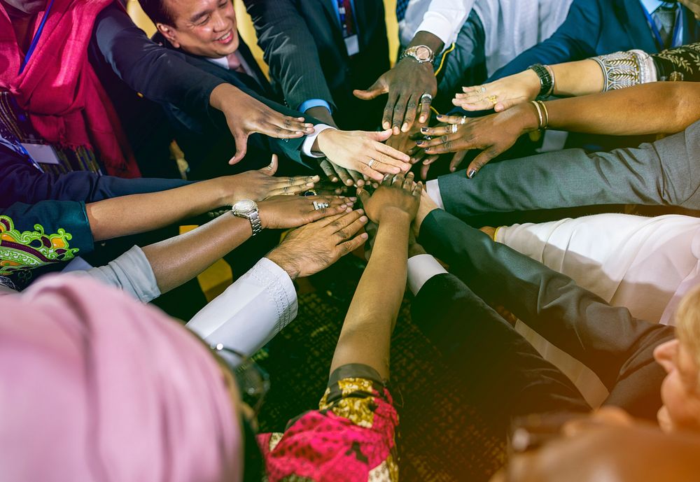 Diverse people hands stack for support together