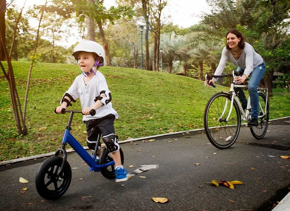 Mother and son cycling in the park