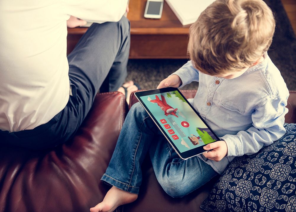 Son Using Tablet E-learning Game Education at Home