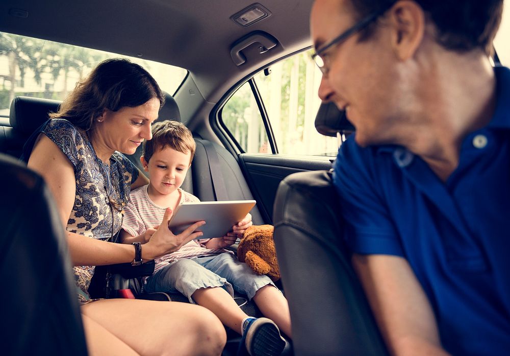 Son and Mom Using Tablet on the Car